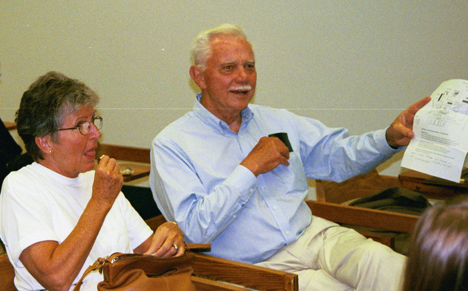 Bill Garrison and his wife look on as others talk.